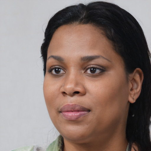 Joyful black young-adult female with medium  black hair and brown eyes