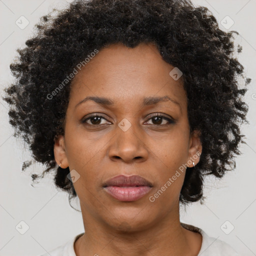 Joyful black adult female with short  brown hair and brown eyes