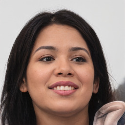 Joyful latino young-adult female with long  brown hair and brown eyes