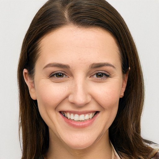 Joyful white young-adult female with long  brown hair and brown eyes