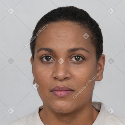 Joyful black young-adult female with short  black hair and brown eyes