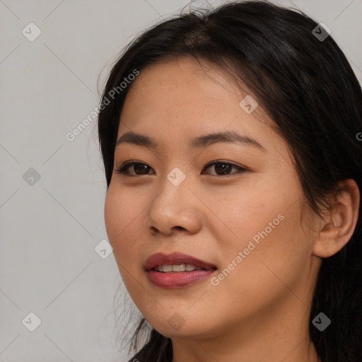 Joyful asian young-adult female with long  brown hair and brown eyes