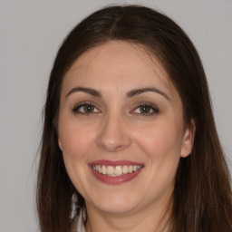 Joyful white adult female with long  brown hair and brown eyes