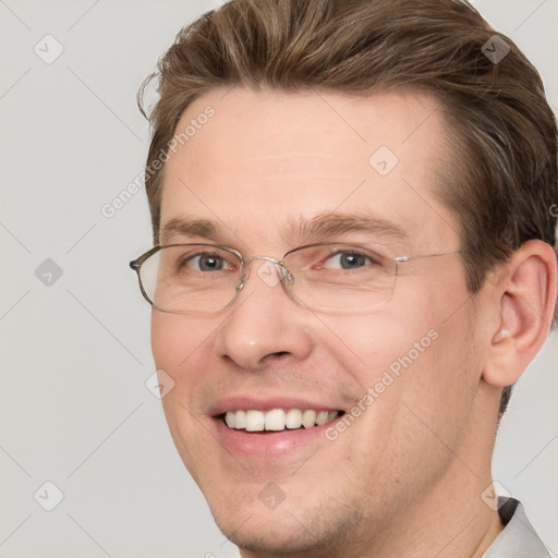 Joyful white adult male with short  brown hair and grey eyes