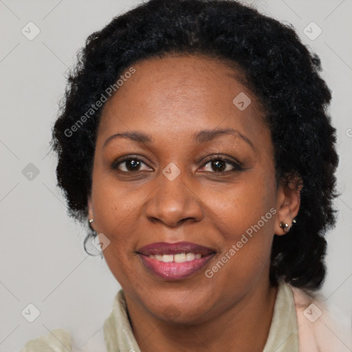 Joyful black adult female with long  brown hair and brown eyes