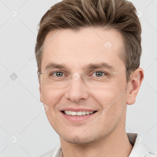 Joyful white young-adult male with short  brown hair and grey eyes