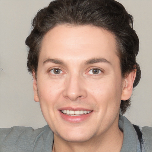 Joyful white young-adult male with medium  brown hair and brown eyes