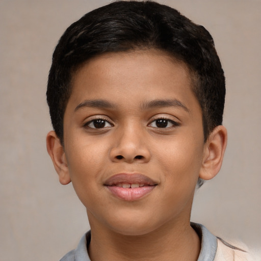 Joyful black child male with short  brown hair and brown eyes