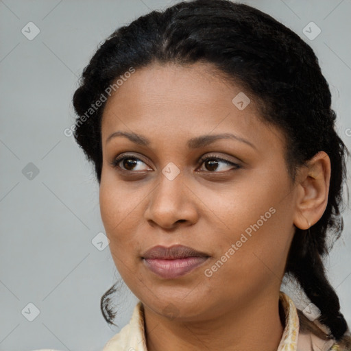 Joyful black young-adult female with long  brown hair and brown eyes