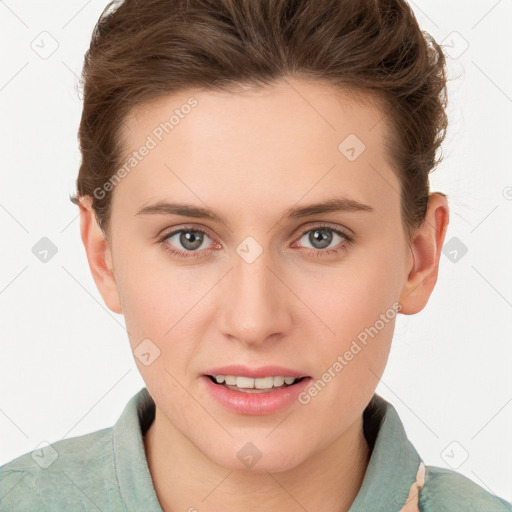 Joyful white young-adult female with short  brown hair and grey eyes