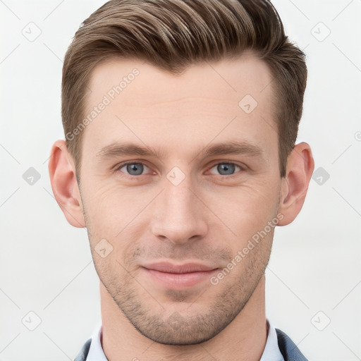 Joyful white young-adult male with short  brown hair and grey eyes