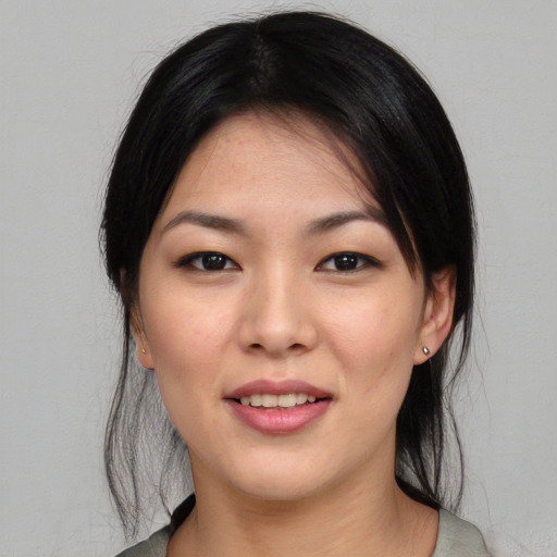 Joyful asian young-adult female with medium  black hair and brown eyes