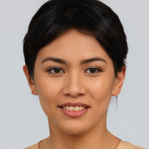 Joyful asian young-adult female with short  brown hair and brown eyes