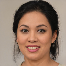 Joyful latino young-adult female with medium  brown hair and brown eyes