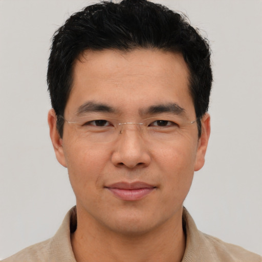 Joyful asian young-adult male with short  black hair and brown eyes