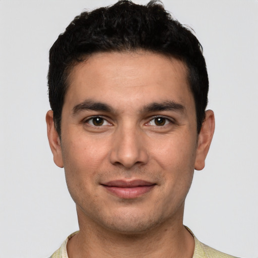 Joyful white young-adult male with short  black hair and brown eyes