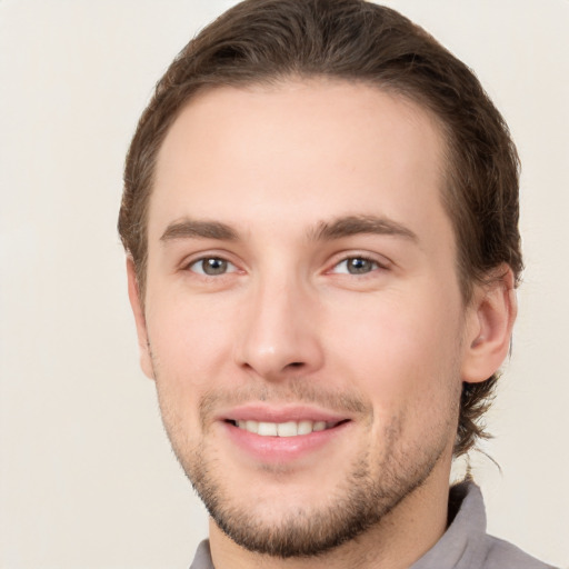 Joyful white young-adult male with short  brown hair and brown eyes