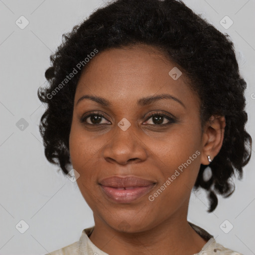 Joyful black adult female with short  brown hair and brown eyes