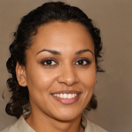 Joyful latino young-adult female with medium  brown hair and brown eyes