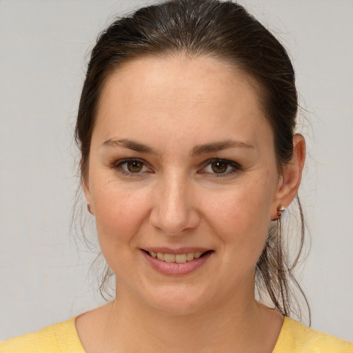 Joyful white young-adult female with medium  brown hair and brown eyes