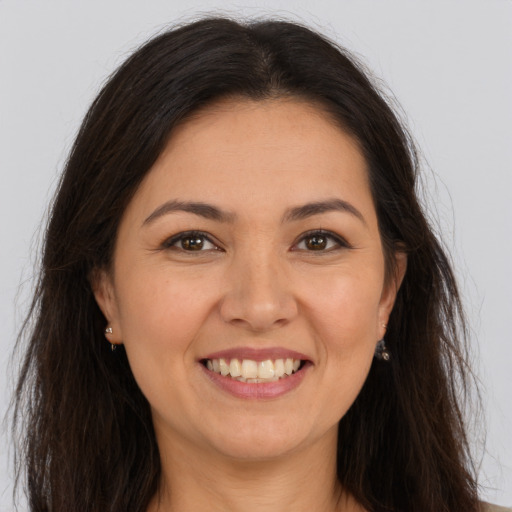 Joyful white young-adult female with long  brown hair and brown eyes