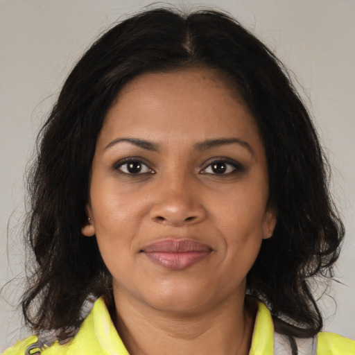 Joyful black young-adult female with medium  brown hair and brown eyes