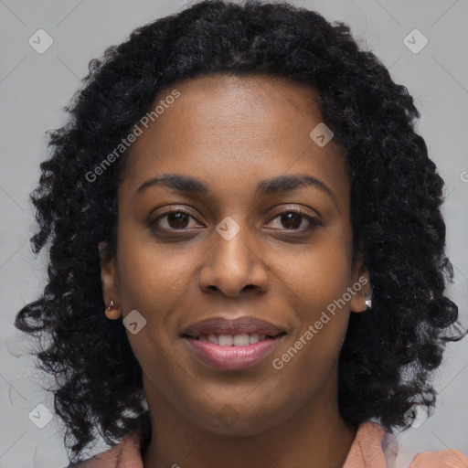 Joyful black young-adult female with long  black hair and brown eyes