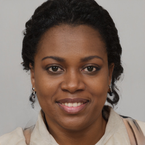 Joyful black young-adult female with medium  brown hair and brown eyes
