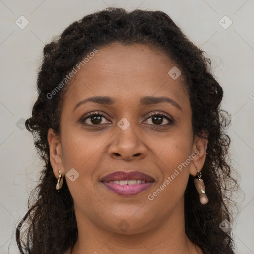 Joyful black young-adult female with long  brown hair and brown eyes