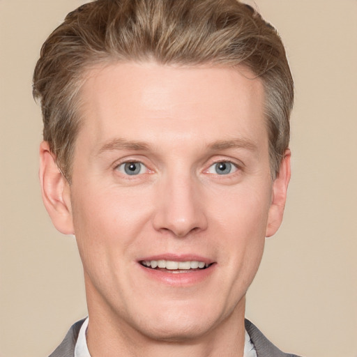 Joyful white adult male with short  brown hair and grey eyes