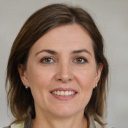 Joyful white adult female with medium  brown hair and brown eyes