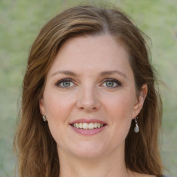 Joyful white young-adult female with medium  brown hair and green eyes