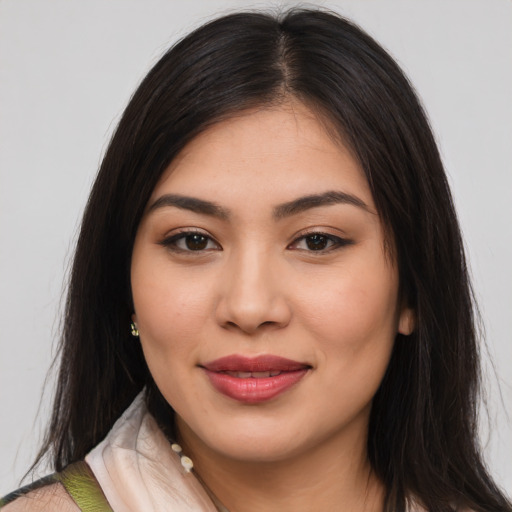 Joyful latino young-adult female with long  brown hair and brown eyes