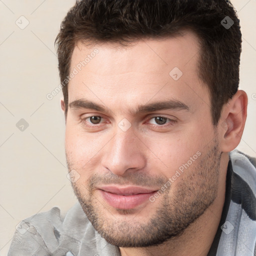 Joyful white young-adult male with short  brown hair and brown eyes