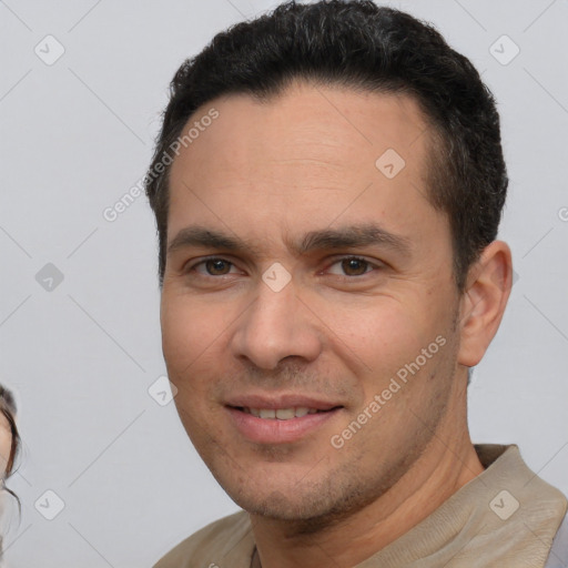 Joyful white adult male with short  brown hair and brown eyes