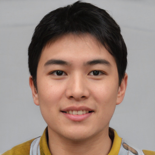 Joyful asian young-adult male with short  brown hair and brown eyes