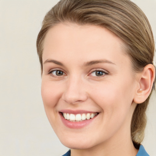 Joyful white young-adult female with medium  brown hair and green eyes