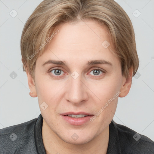 Joyful white young-adult female with short  brown hair and grey eyes