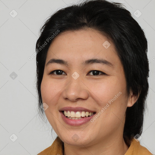 Joyful asian young-adult female with medium  brown hair and brown eyes