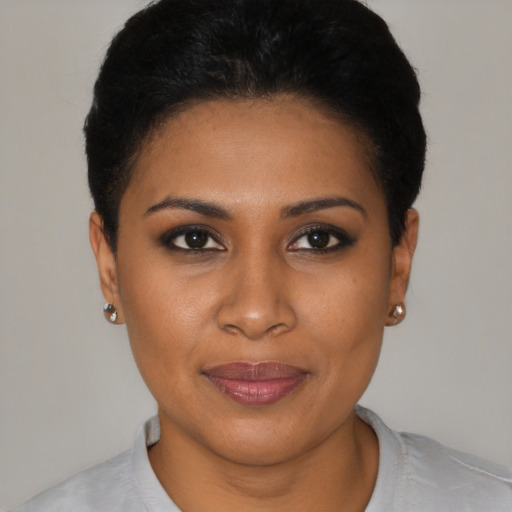 Joyful black young-adult female with short  black hair and brown eyes