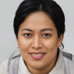 Joyful asian adult female with short  brown hair and brown eyes