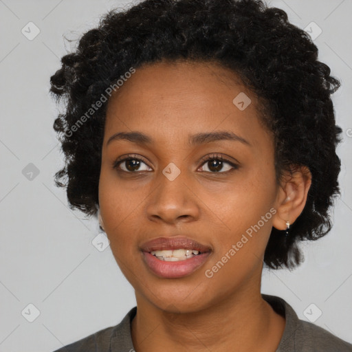 Joyful black young-adult female with short  black hair and brown eyes