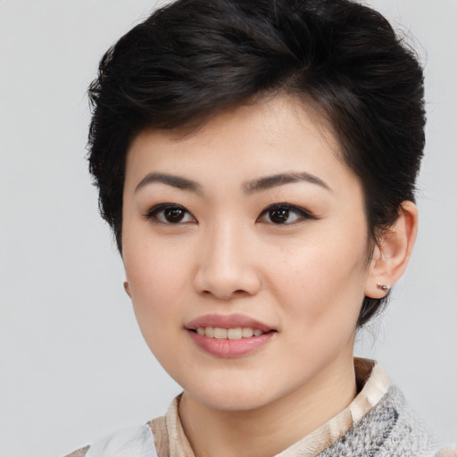 Joyful asian young-adult female with medium  black hair and brown eyes