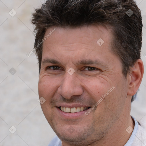 Joyful white adult male with short  brown hair and brown eyes