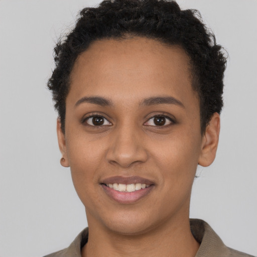 Joyful black young-adult female with short  brown hair and brown eyes