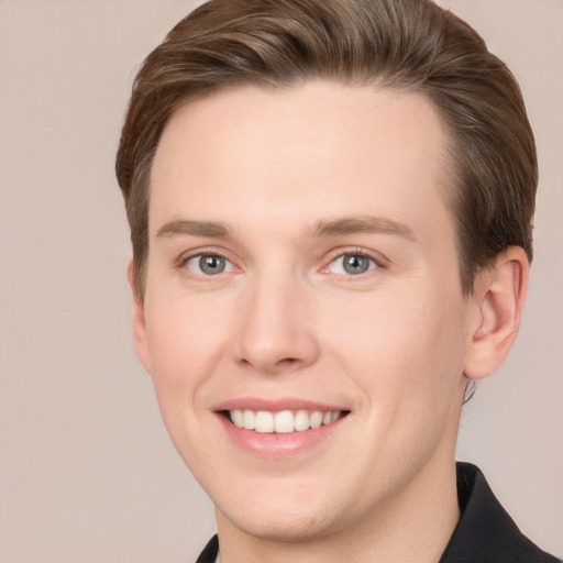 Joyful white young-adult male with short  brown hair and grey eyes