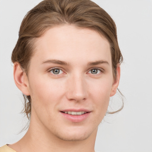 Joyful white young-adult female with short  brown hair and grey eyes