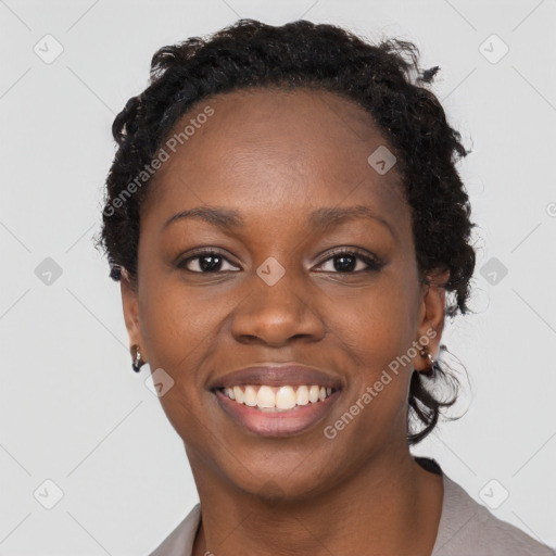 Joyful black young-adult female with long  brown hair and brown eyes