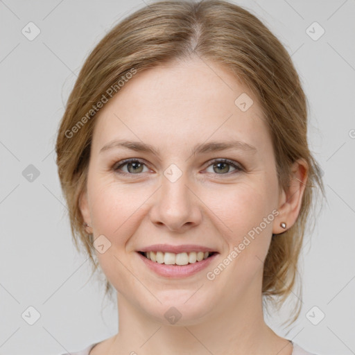 Joyful white young-adult female with medium  brown hair and grey eyes