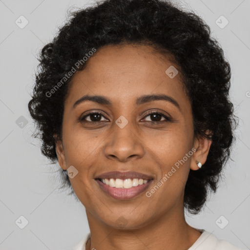 Joyful black young-adult female with long  black hair and brown eyes